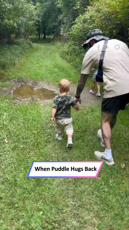 Little boy slips and falls into puddle