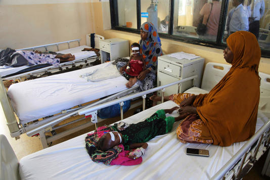 Women sit with malnourished children at Banadir Hospital in Mogadishu, Somalia (Photo/Farah Abdi Warsameh, File)