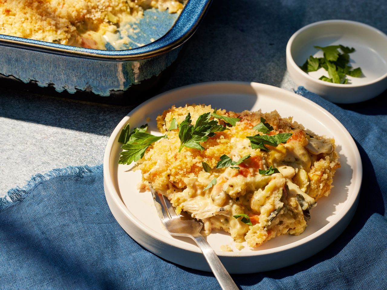 Zucchini Chicken Casserole garnished with fresh herbs on a plate with a fork