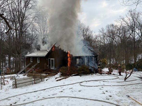 Dog alerts owner to house fire, Amazon driver helps rescue woman
