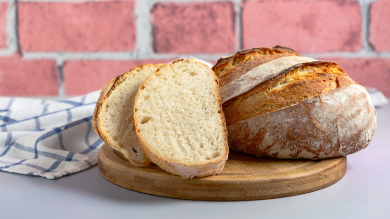 soudough loaf and slices on cutting board
