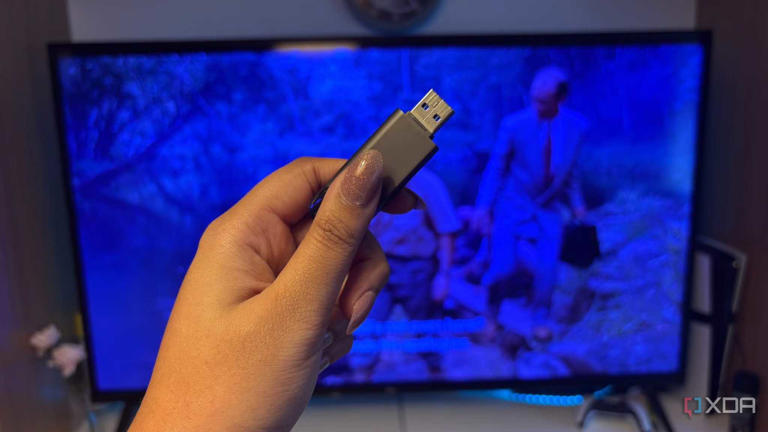 USB in front of TV with film playing in the background