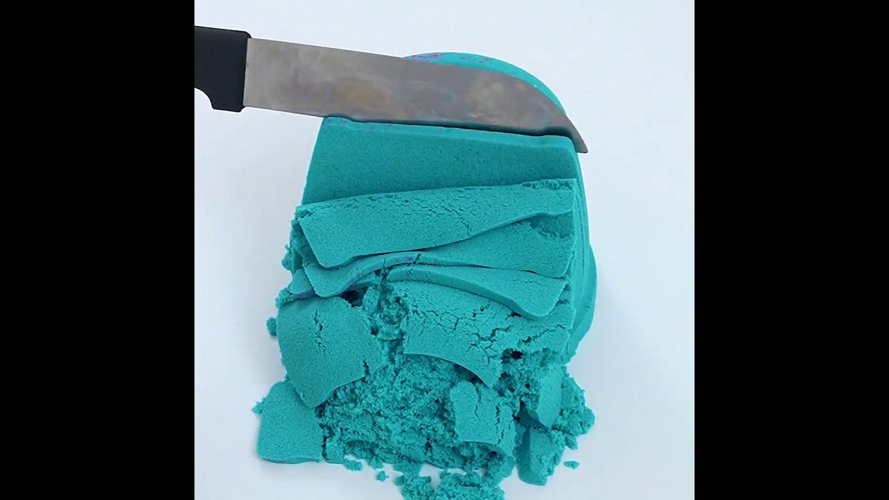 Knife cutting teal color sand ASMR
