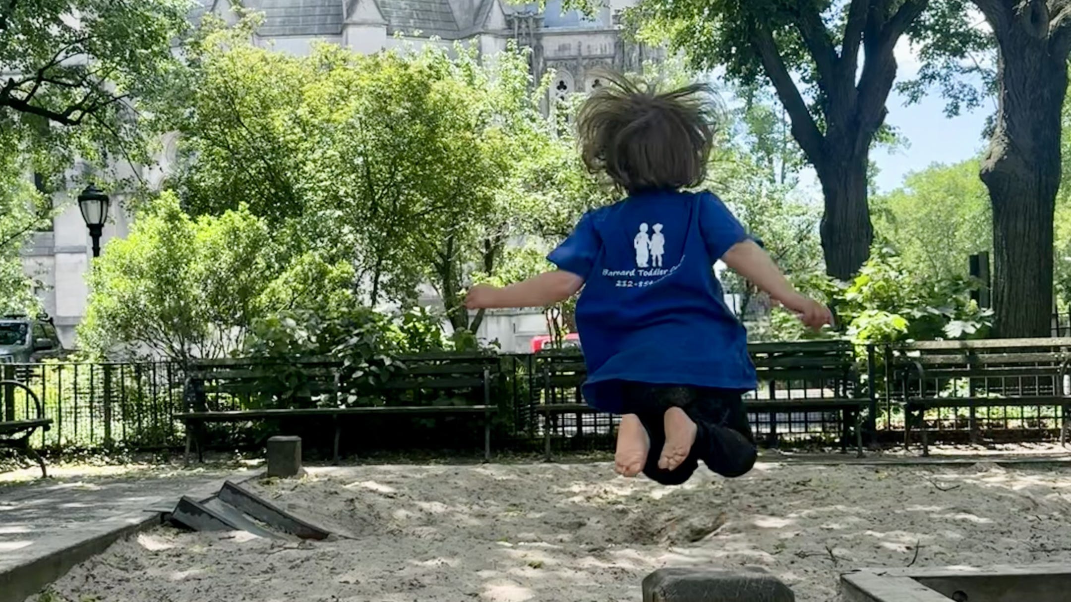 Child jumping on sand