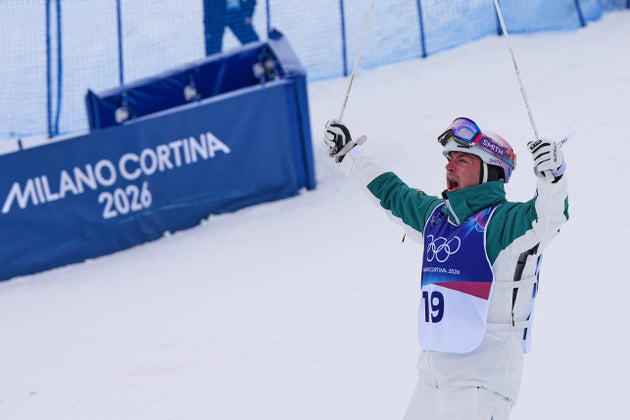Cooper Woods celebrates his gold medal victory. via Associated Press