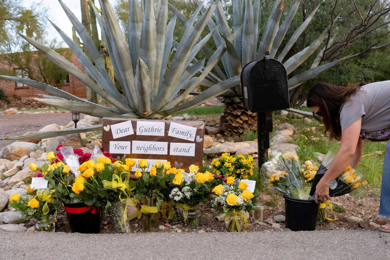 Rebecca Noble/Reuters - PHOTO: A well-wisher leaves flowers outside of Nancy Guthrie's home in the Catalina Foothills in Tucson, Arizona, February 11, 2026.