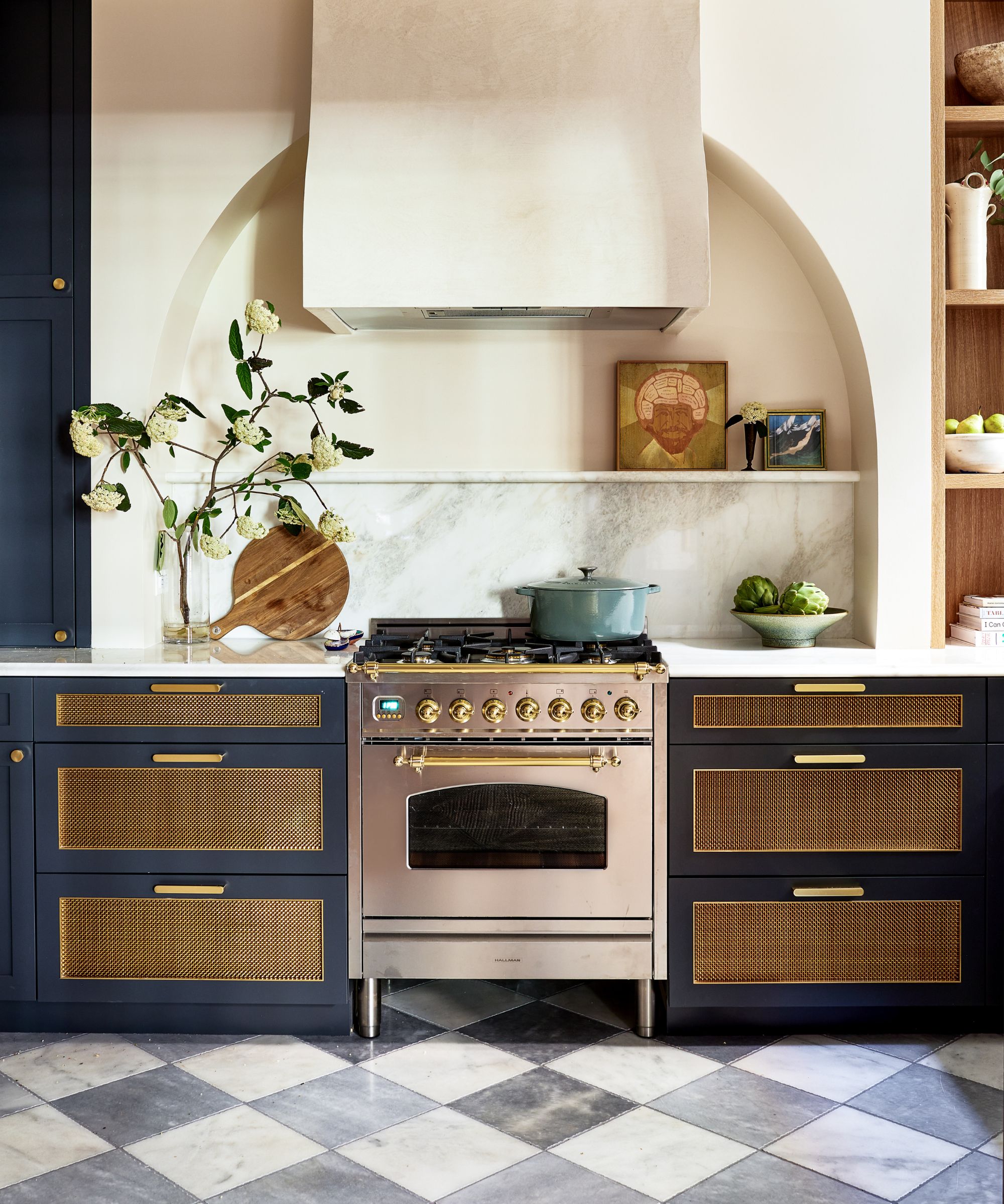A small kitchen with blue and rattan cabinets, white walls, and a marble countersplash
