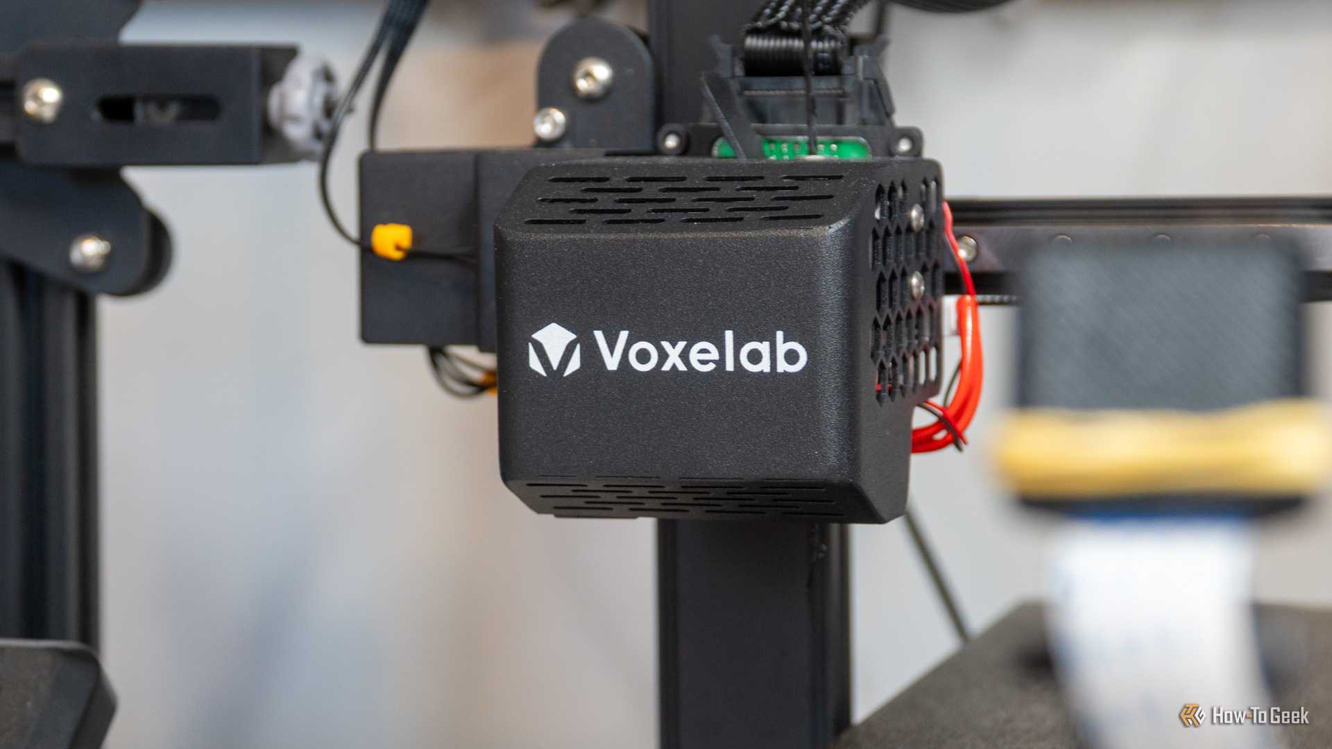 The print head of the Voxelab D1 3D printer with an auto bed leveling system inside.