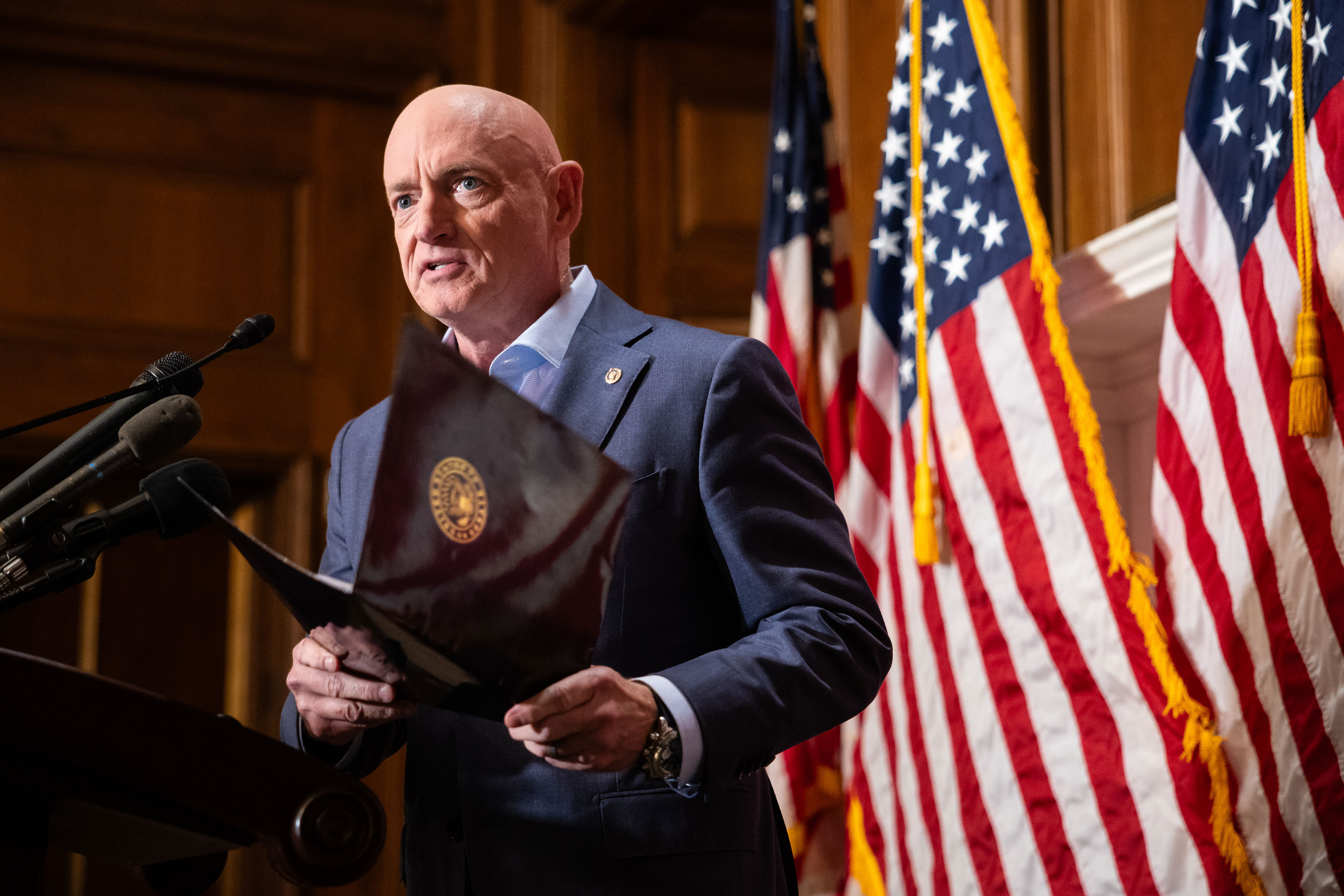 "This is about the free speech rights of over 2 million retired veterans. ... He's going after them," Sen. Mark Kelly said of the president.