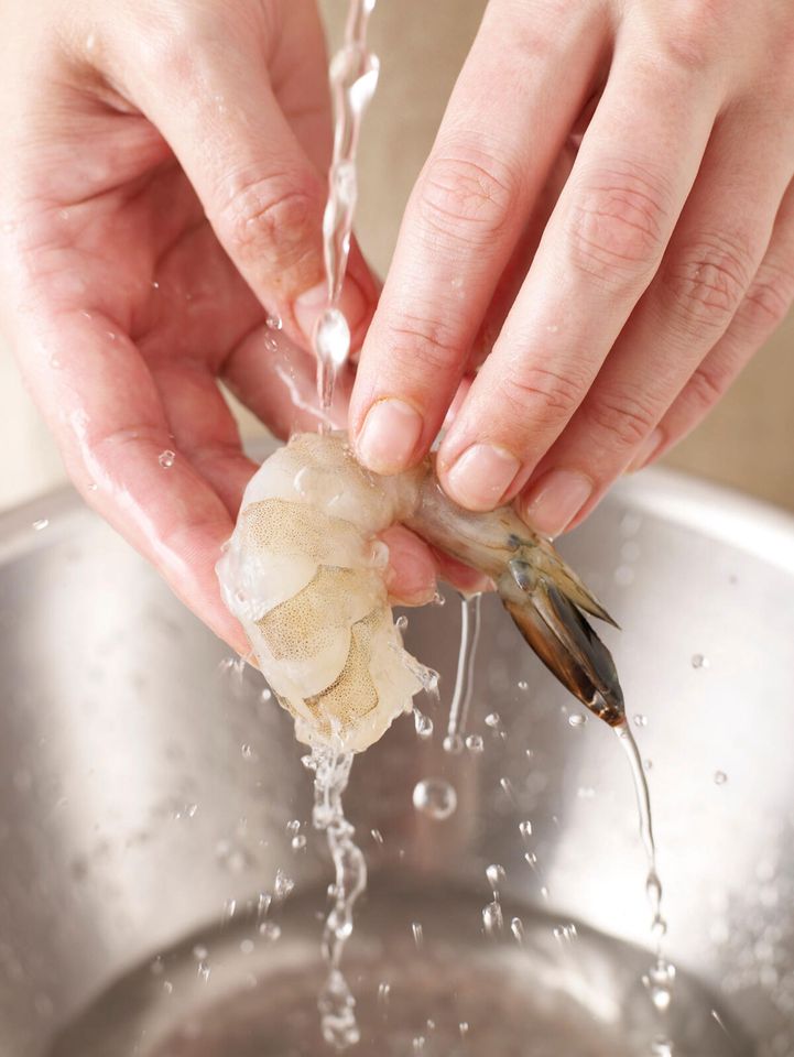 Hands washing shrimp