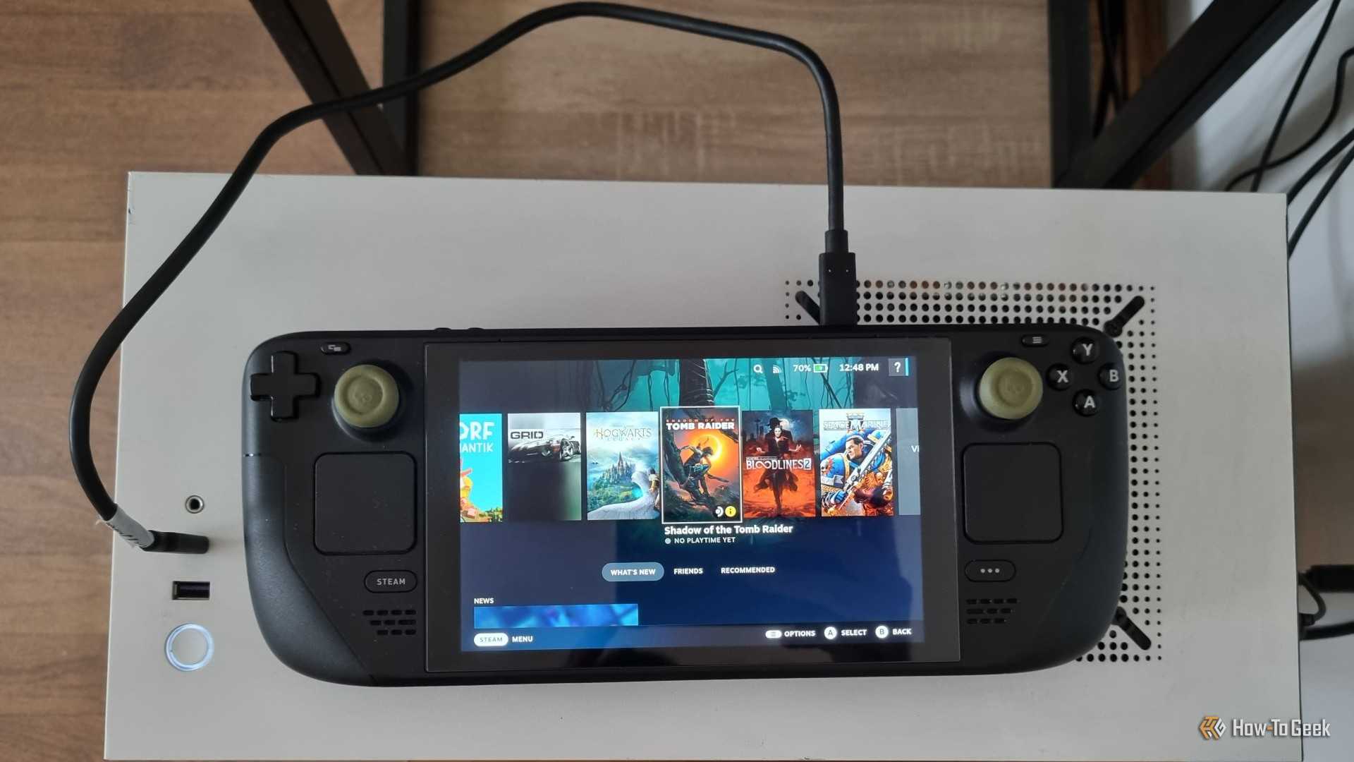 A Steam Deck Connected to a PC with a USB Cable.