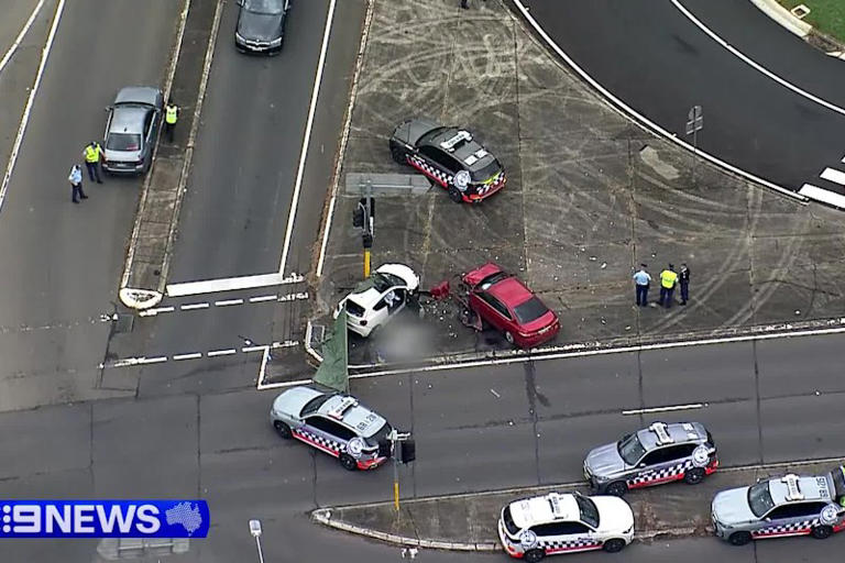 Two women are dead after a man who led police on an hour-long chase across Sydney’s south-west in a stolen vehicle crashed into their car, before being arrested at gunpoint.