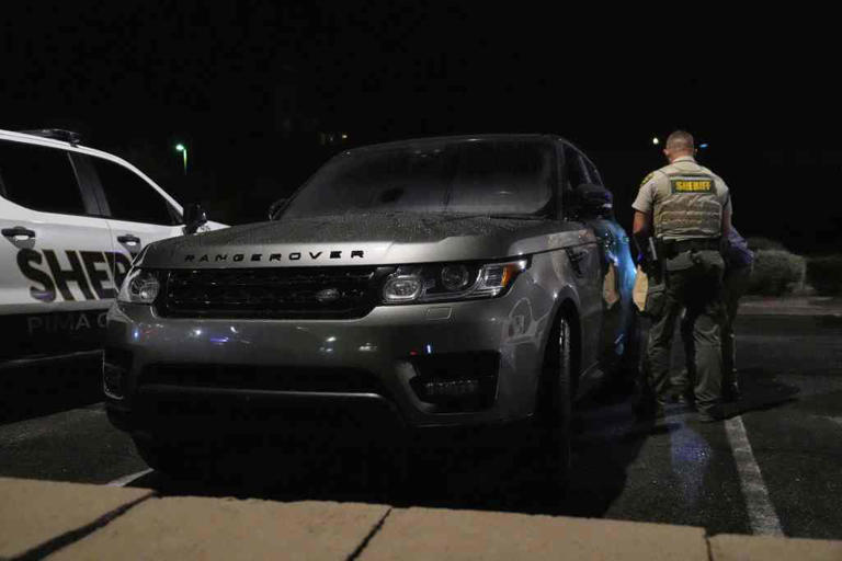 A Range Rover in a Culver’s parking lot in Tucson, Arizona, is checked over before being towed away early Saturday, February 14, 2026.