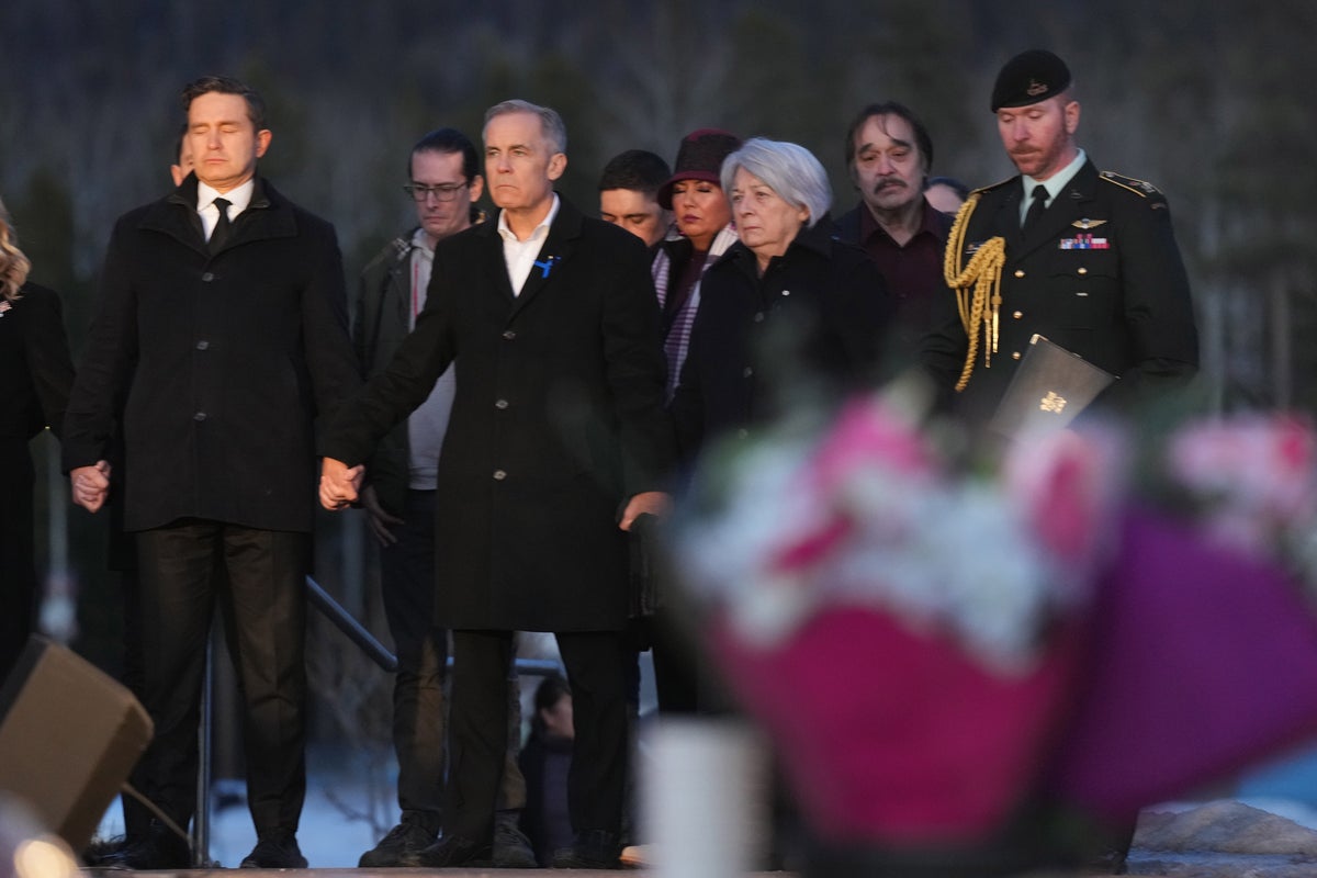 Canadian PM and opposition leader join hands at mass shooting vigil