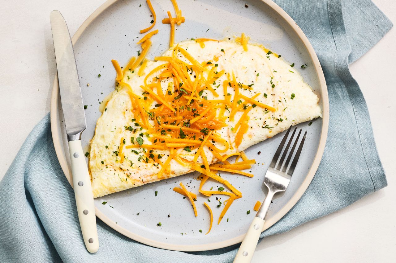 Southern Living Egg White Omelette on a plate garnished with cheese and herbs