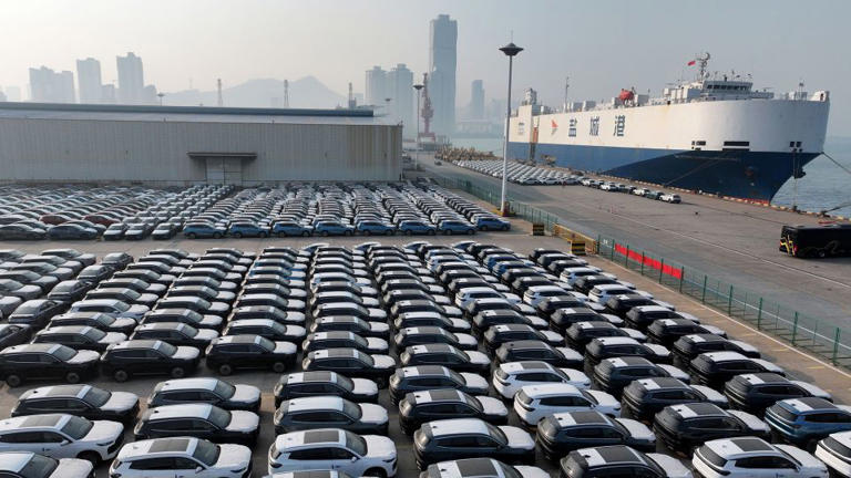 Aerial view of new vehicles waiting for shipment to overseas markets in a port in Lianyungang in eastern China. - FeatureChina/AP