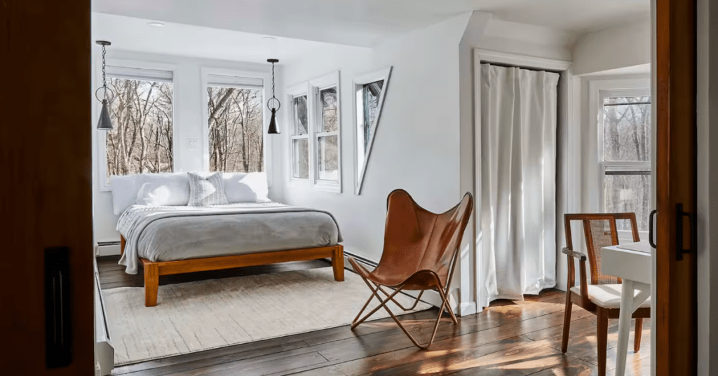 Airy bedroom with forest views in an Alpine-style A-frame Airbnb located in North Kingstown, Rhode Island.