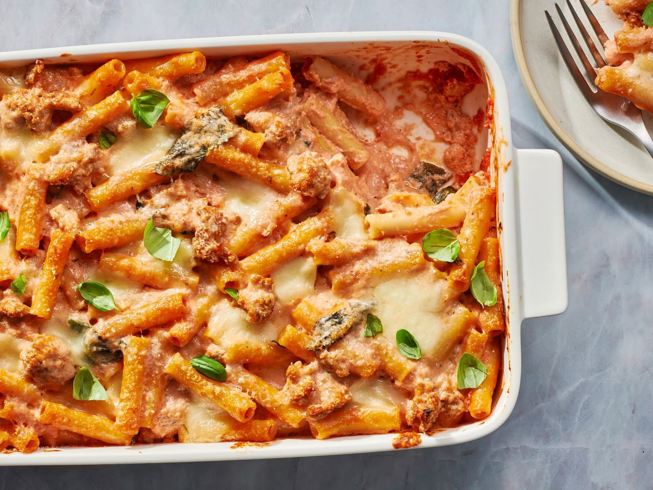Baked ziti casserole with sausage, spinach, and melted cheese