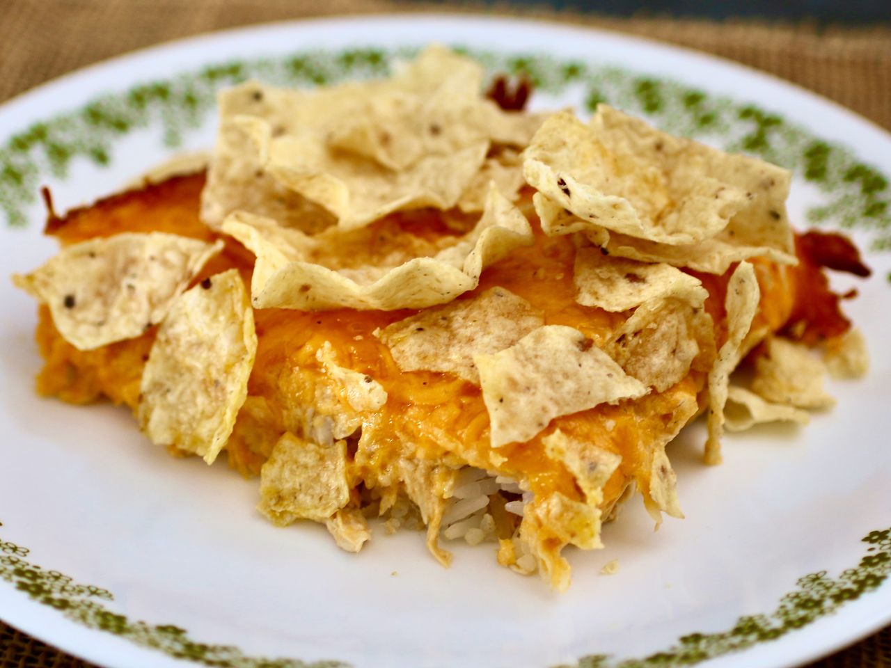 close up of chicken casserole topped with chips on plate
