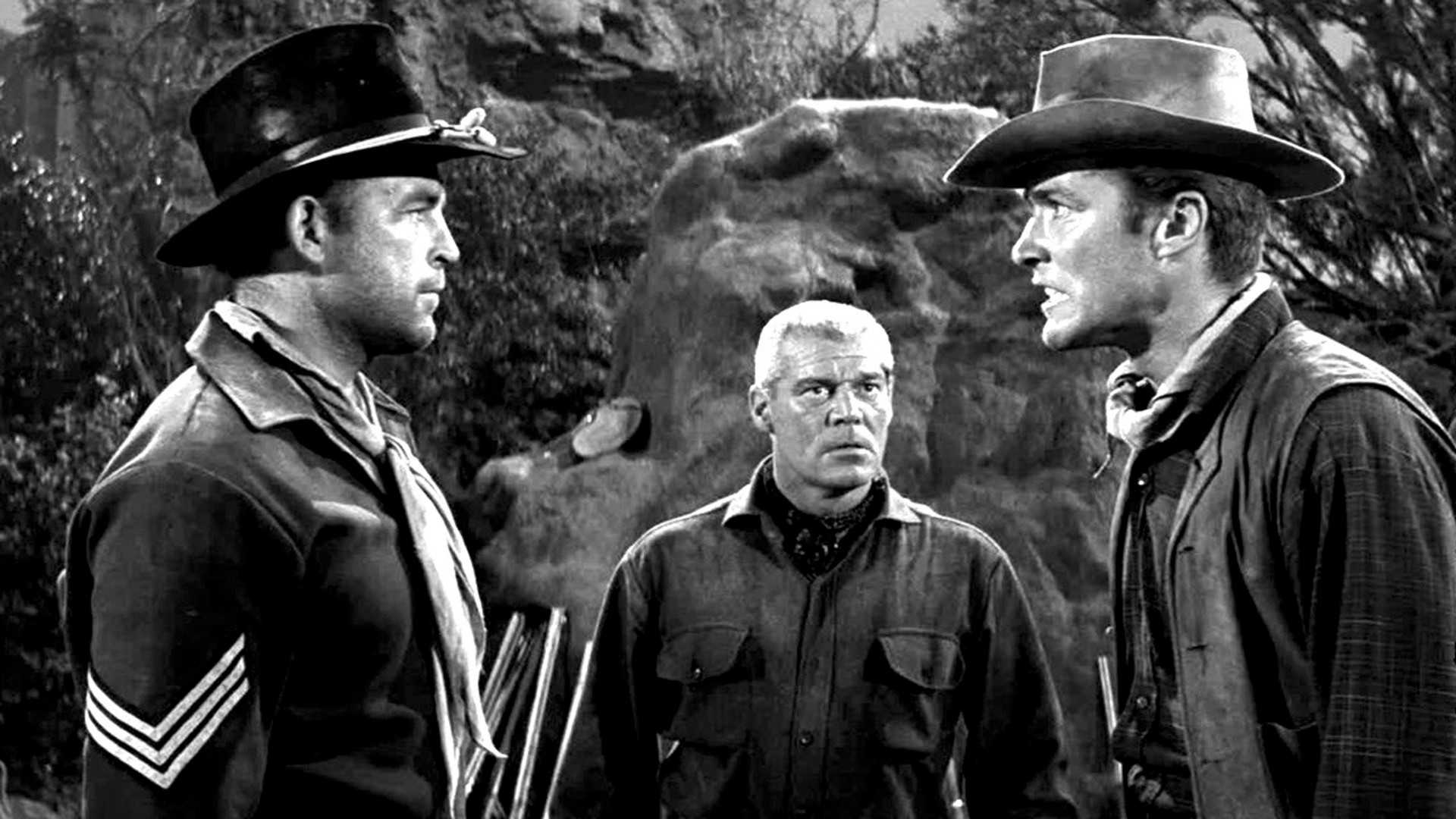 Clint Eastwood argues with another man in Ambush at Cimarron Pass