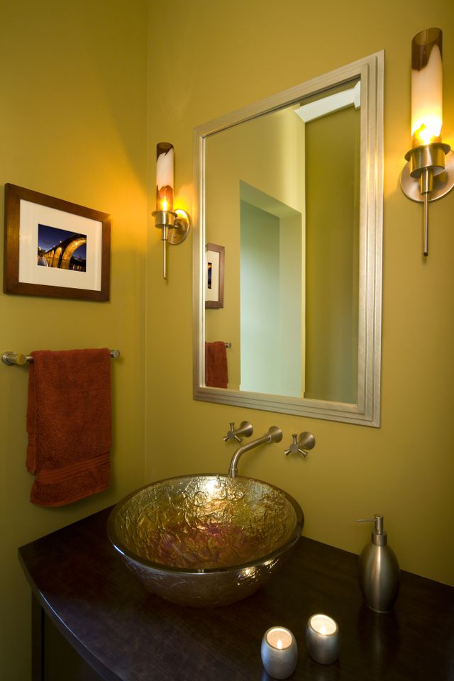 Stylish Powder Room with Mustard Yellow Walls and Glass Vessel Sink