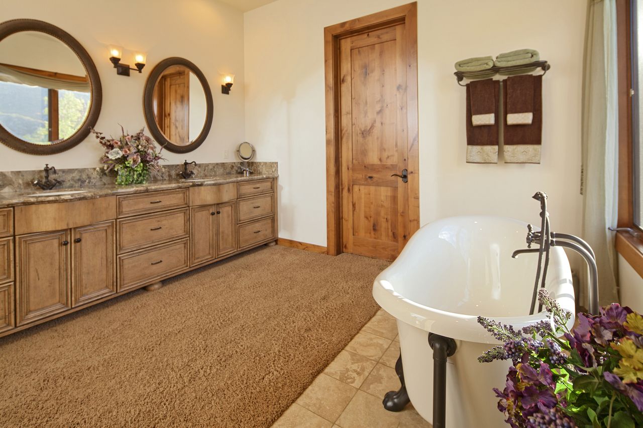 Tuscan style bathroom with carpeting and clawfoot tub
