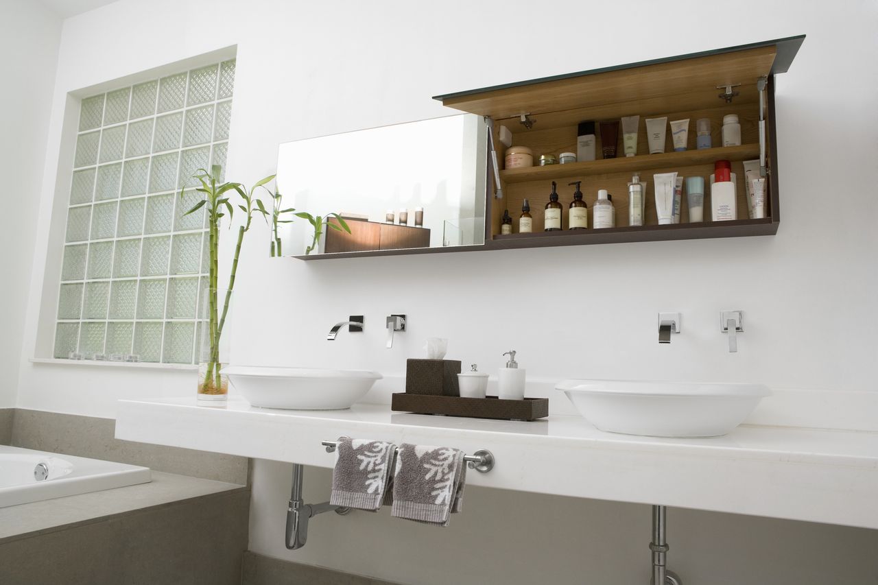 Toiletries in a modern bathroom with a privacy block glass window