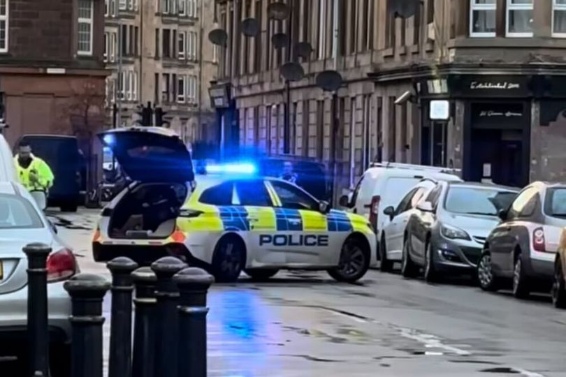 Two men arrested after woman 'attacked' as police seal off Glasgow street