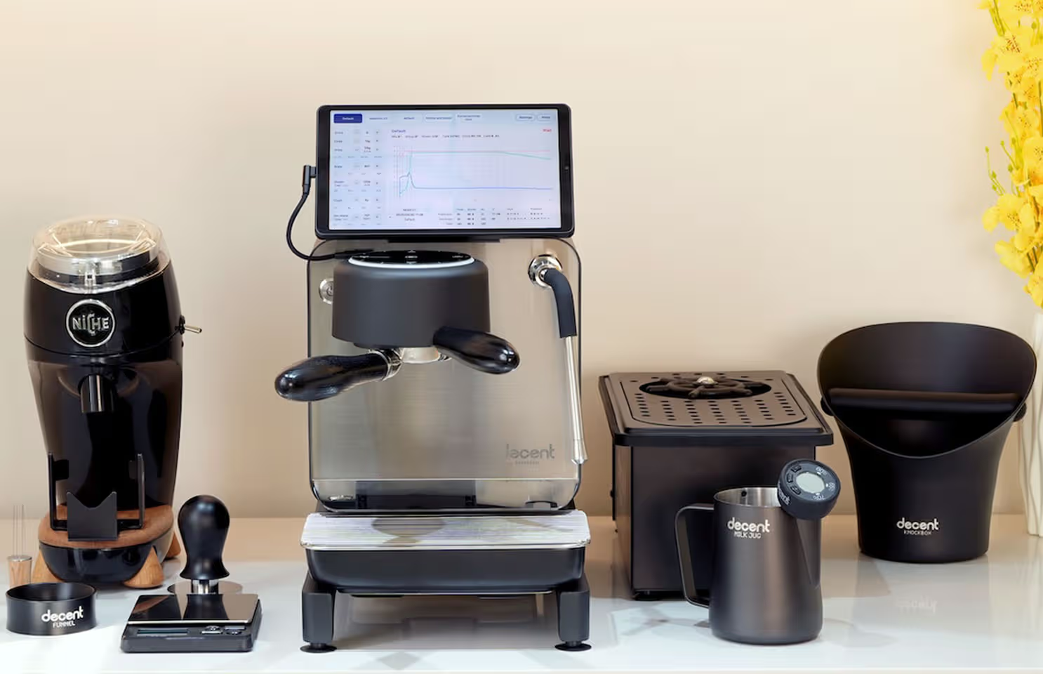 A Decent DE1 espresso machine on a countertop along with other coffee making equipment.
