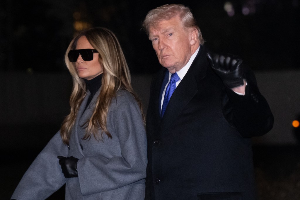 President Donald Trump and first lady Melania Trump walk across the South Lawn of the White House after arriving on Marine One following a weekend trip to Florida, in Washington, DC, on February 16. (Photo by SAUL LOEB / AFP via Getty Images)