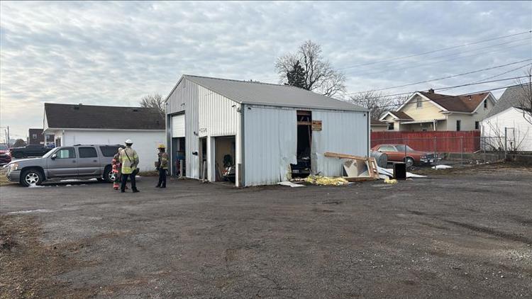 Vehicle crashes into west Toledo building, knocks out power pole