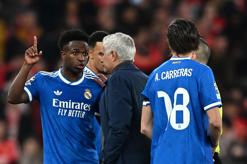 Vinicius Junior of Real Madrid speaks to Jose Mourinho, Head Coach of Benfica, after a clash with Gianluca Prestianni during the UEFA Champions League 2025/26 League Knockout Play-off First Leg match between SL Benfica and Real Madrid C.F. at Estadio do SL Benfica on February 17, 2026 in Lisbon, Portugal