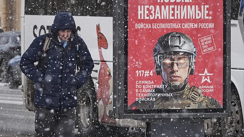 A man walks past a billboard promoting contract military service in the Russian army's unmanned systems units, in St. Petersburg, Russia, Wednesday, Feb. 4, 2026