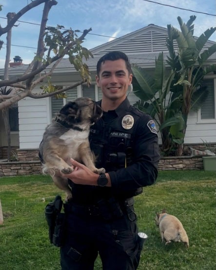 Social media swoons as photo of California cop with pups goes viral