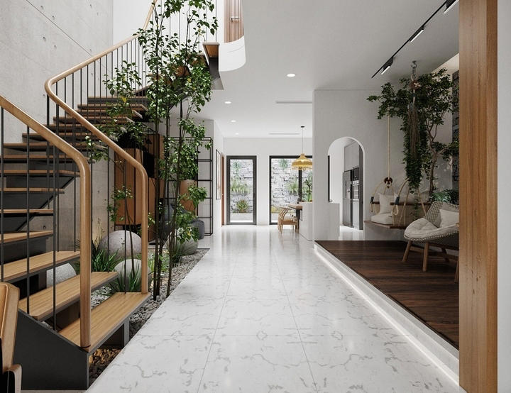 Tiểu cảnh gồm cây xanh và sỏi đá dưới gầm cầu thang. (Ảnh: Decoxdesign)