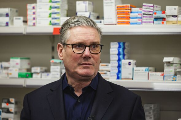 Sir Keir Starmer in front of rows of pills