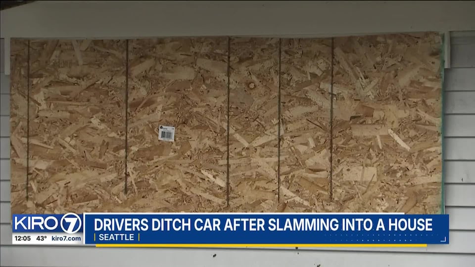 Video: Drivers ditch car after slamming into a house