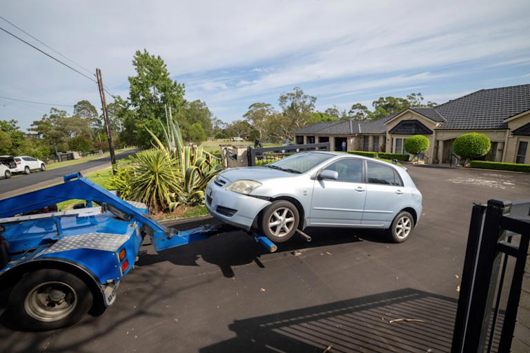 A car is towed from the Kenthurst property.