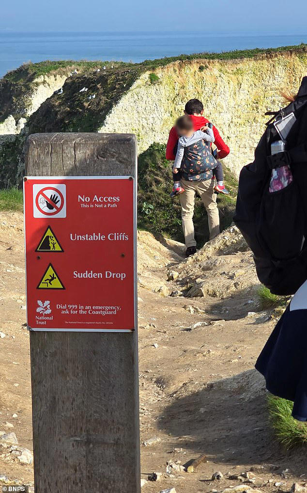 foolhardy-father-carrying-young-child-in-backpack-risks-their-lives-to