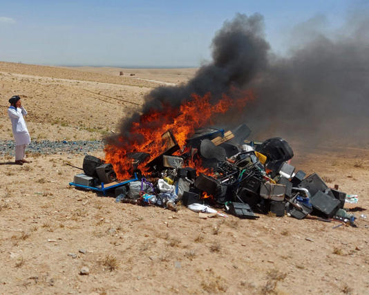 Taliban stand guard after setting fire to a pile of musical instruments on the outskirts of Herat, July 2023. Photograph: Ministry for the Propagation of Virtue and the Prevention of Vice/AFP/Getty Images