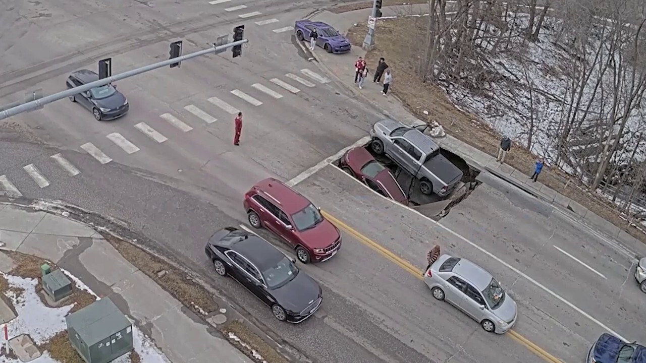 Video captures heart-dropping moment sinkhole collapses underneath multiple cars<br><br>