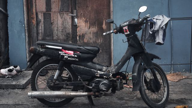 a motorcycle parked in front of a blue building