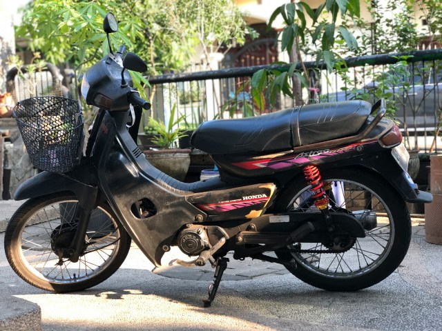 a motor scooter parked on the side of the road