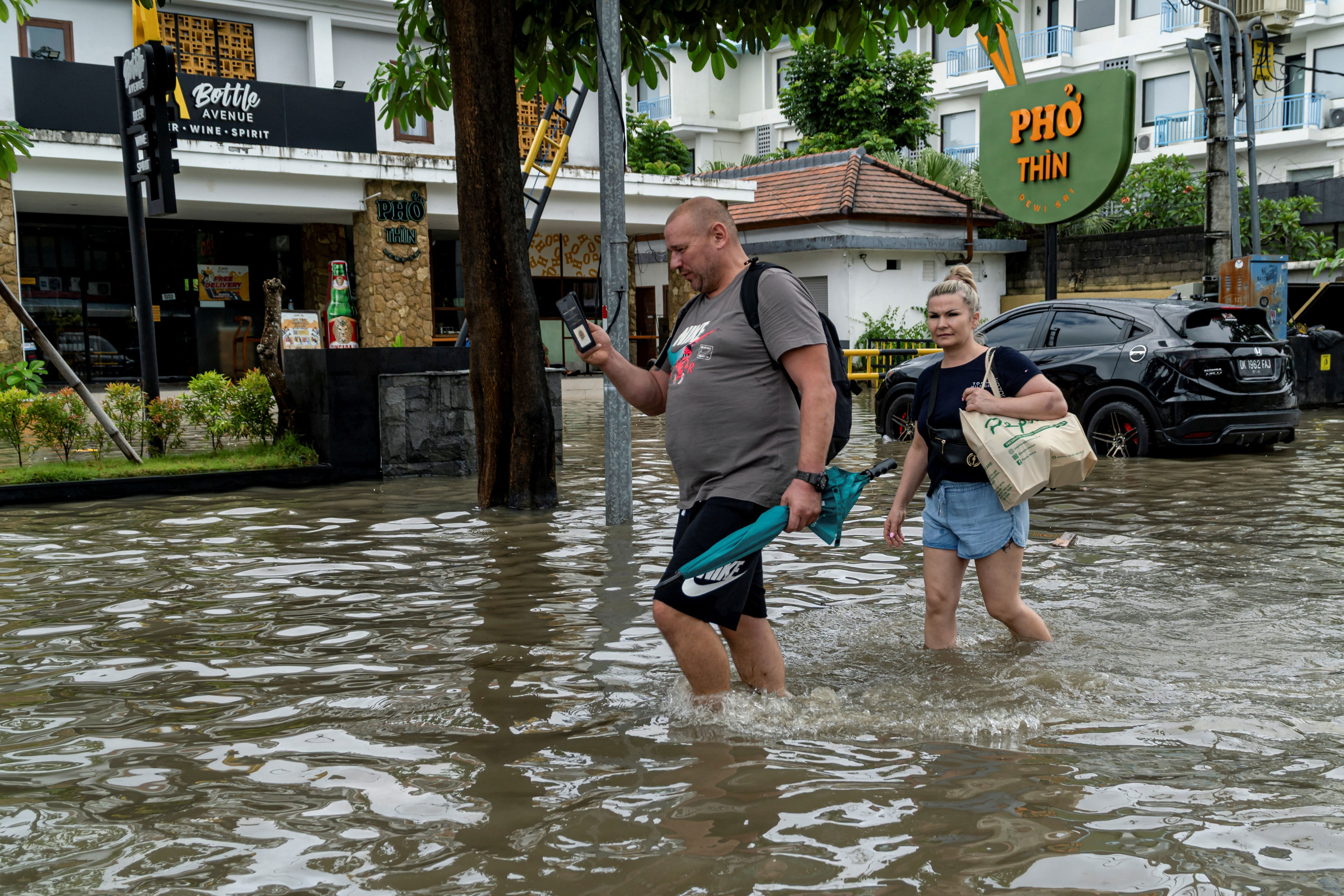 Watch: Giant python swims through flooded road in Bali amid historic rain