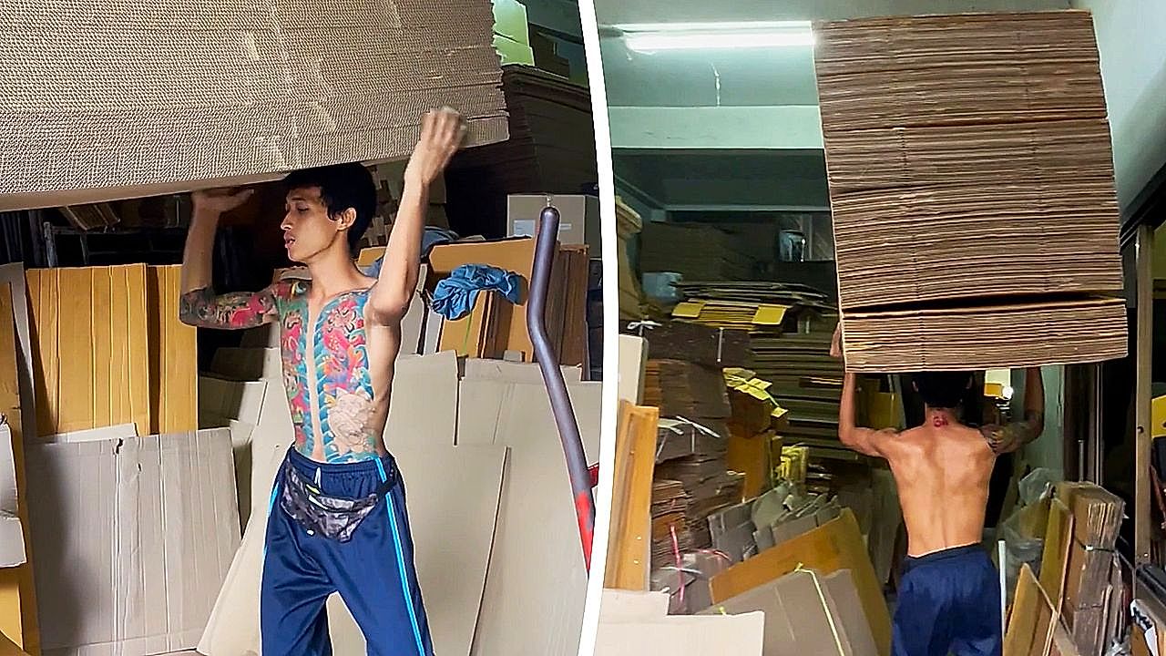 Worker amazes warehouse with towering cardboard-stack carry