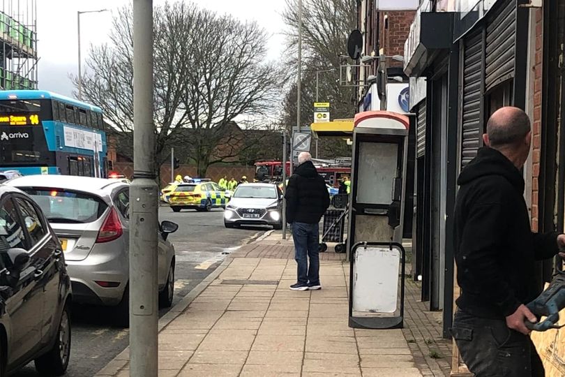 Car 'flips on its roof' and man detained after crash on major road