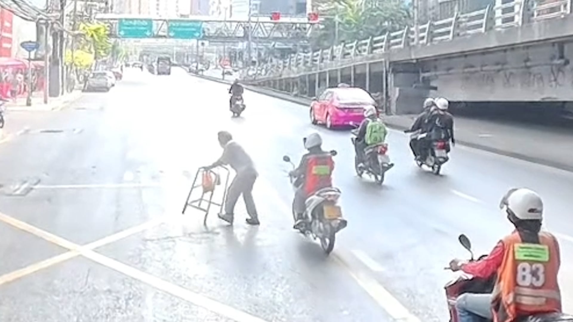 Bus driver and motorist help elderly woman cross busy road