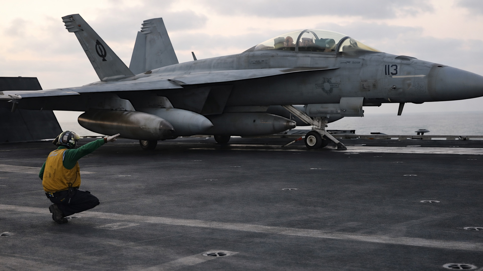 US Navy fighter jet prepares for takeoff on aircraft carrier