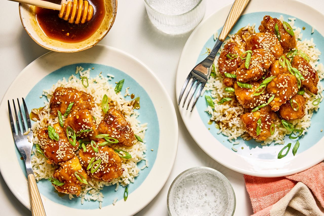 Honey Garlic Chicken Nuggets served on plates over rice