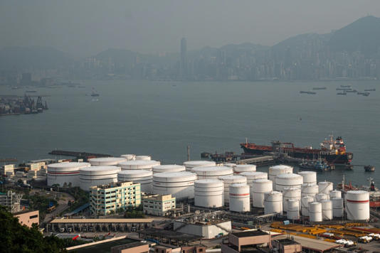 China Petroleum & Chemical Corp. storage tanks at the container terminal in Hong Kong.